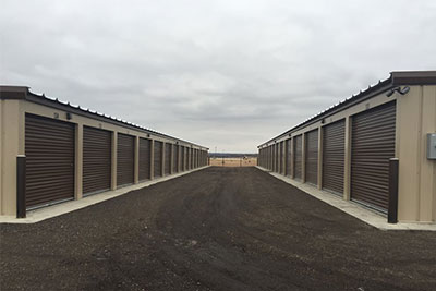 Two self-storage buildings featuring overhead roll-up garage doors at Randolph Storage